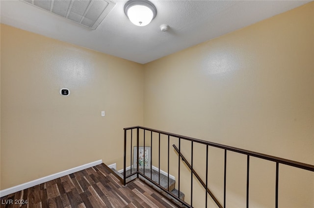 staircase with hardwood / wood-style flooring