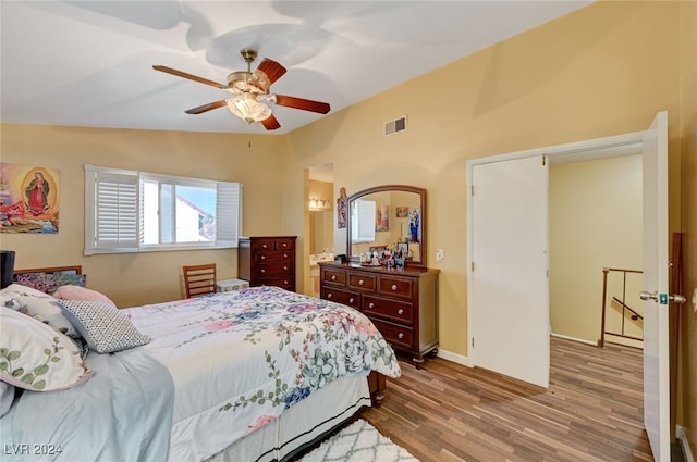 bedroom featuring hardwood / wood-style flooring, ceiling fan, and lofted ceiling