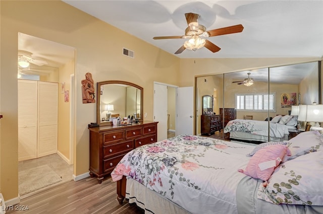 bedroom featuring hardwood / wood-style flooring, ceiling fan, a closet, and vaulted ceiling