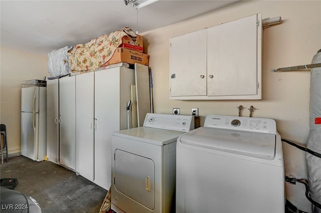 laundry area with cabinets and washing machine and clothes dryer