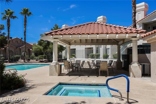 view of swimming pool featuring a gazebo, a hot tub, and a patio