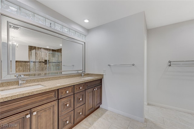 bathroom featuring tile patterned flooring, a shower with door, and vanity