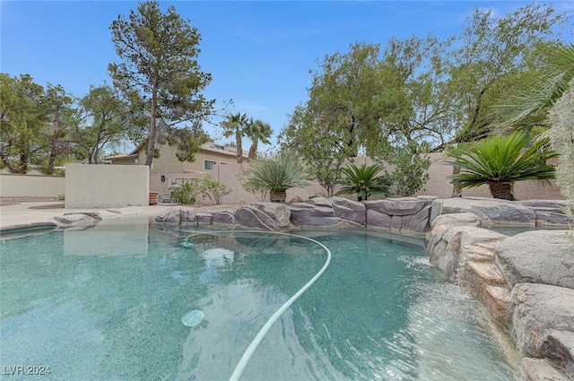 view of pool with pool water feature