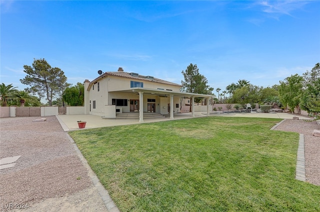 rear view of house featuring a yard and a patio area