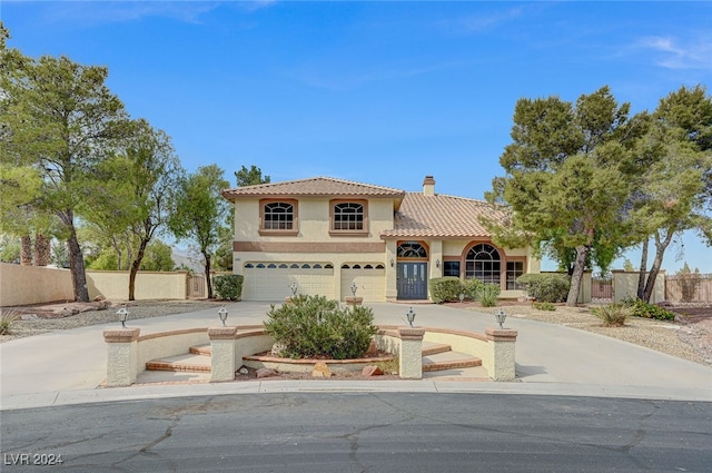 mediterranean / spanish-style house featuring a garage