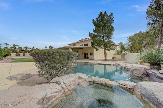 view of pool with an in ground hot tub and a patio