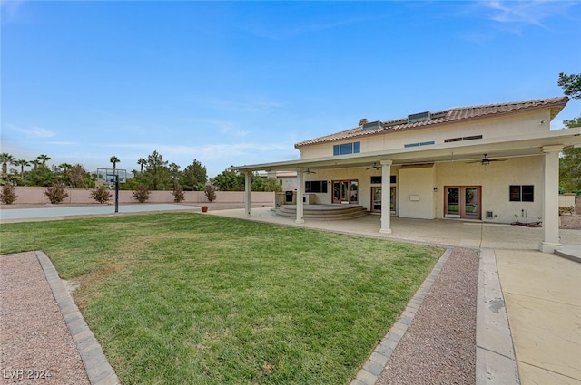 rear view of house with a yard, ceiling fan, french doors, and a patio area