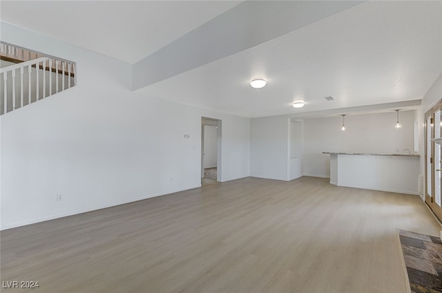 unfurnished living room featuring wood-type flooring