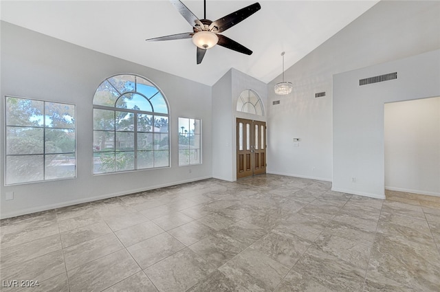 unfurnished living room featuring high vaulted ceiling and ceiling fan