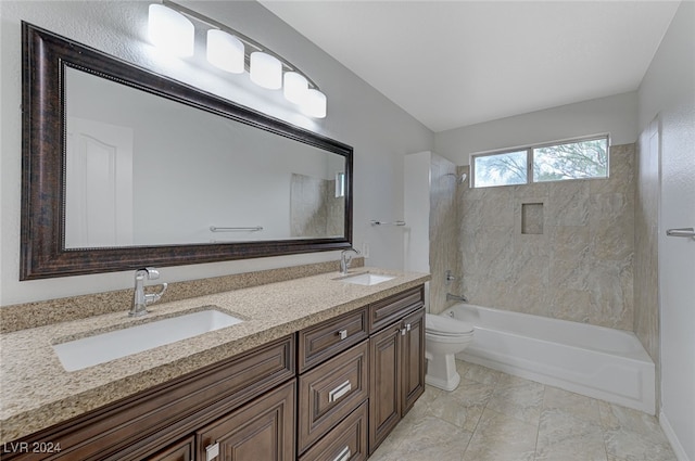 full bathroom featuring vanity, tiled shower / bath combo, and toilet