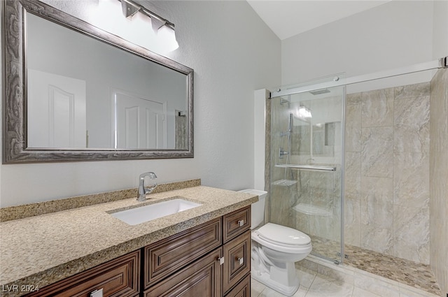 bathroom with a shower with door, vanity, and toilet