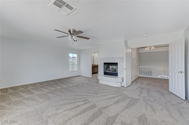 unfurnished living room featuring light colored carpet, a multi sided fireplace, and ceiling fan