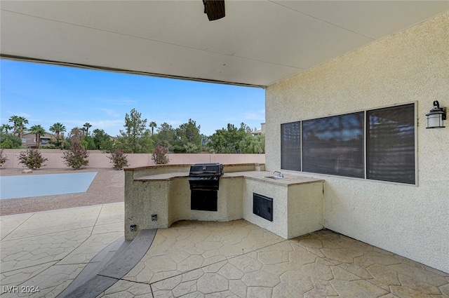 view of patio featuring area for grilling and sink