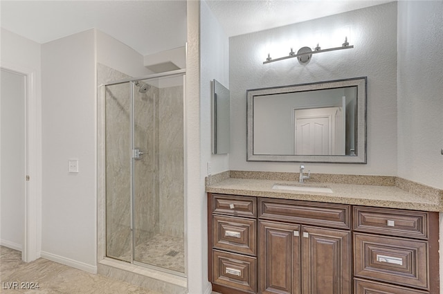 bathroom featuring vanity, a shower with door, and tile patterned floors