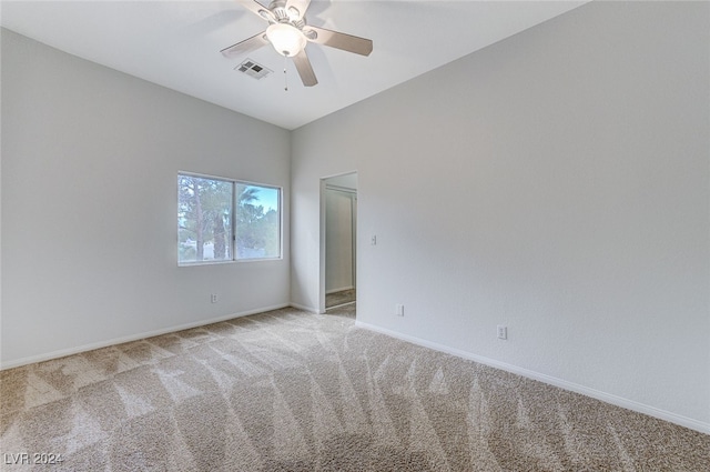 spare room featuring light colored carpet and ceiling fan