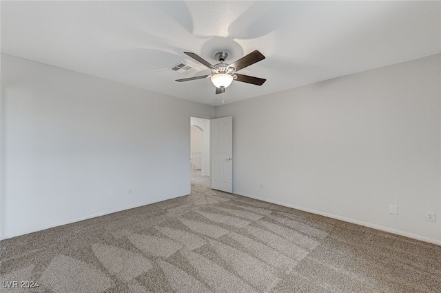 carpeted spare room with ceiling fan