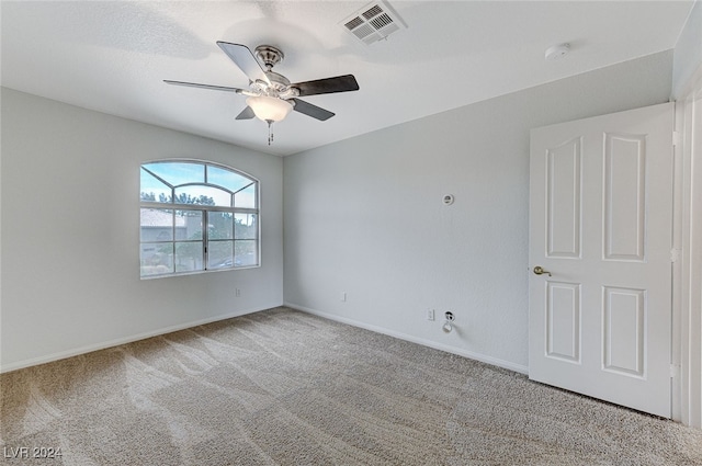 empty room with ceiling fan and carpet