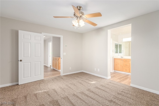 empty room with light colored carpet and ceiling fan