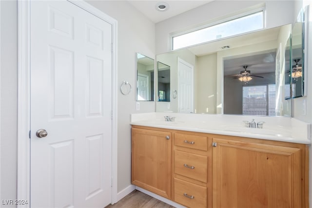 bathroom featuring wood-type flooring, vanity, and ceiling fan