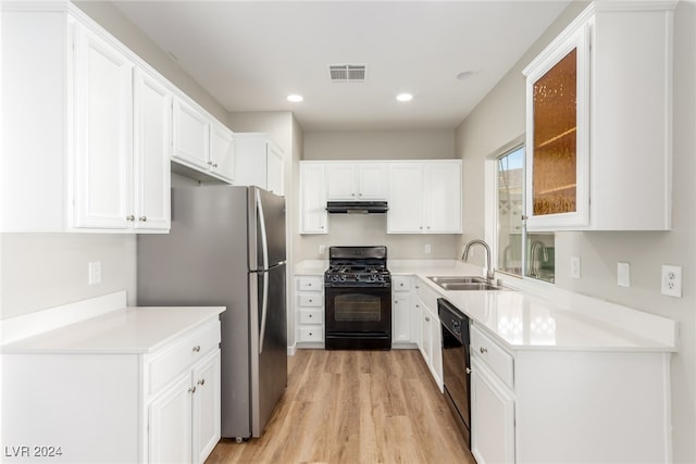 kitchen with white cabinets, light wood-type flooring, sink, and black appliances