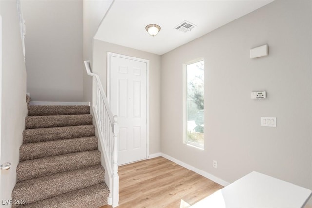 foyer entrance with light hardwood / wood-style flooring