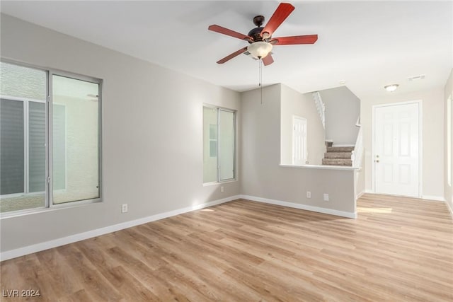 spare room featuring ceiling fan and light wood-type flooring