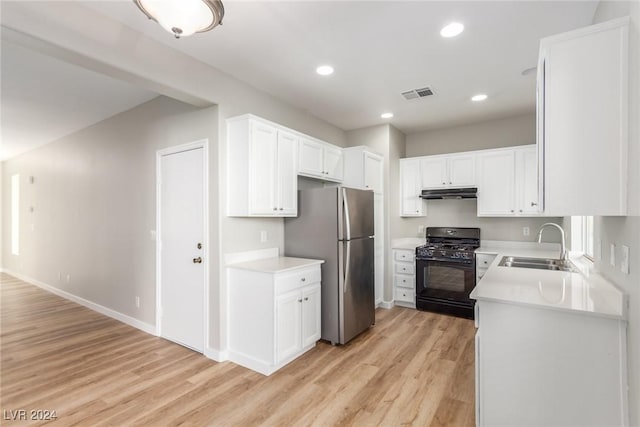 kitchen with stainless steel fridge, black gas range oven, sink, light hardwood / wood-style floors, and white cabinetry