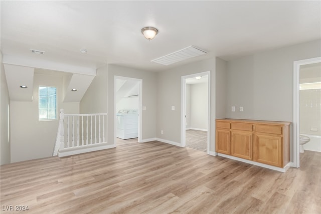 interior space with light wood-type flooring and washer / clothes dryer