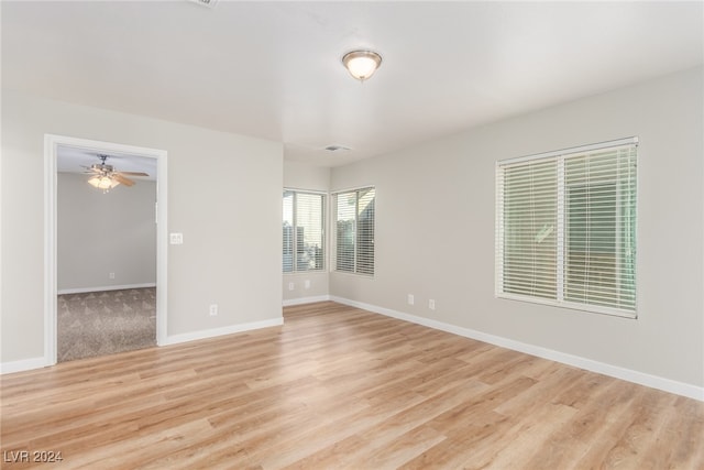 spare room featuring ceiling fan and light wood-type flooring