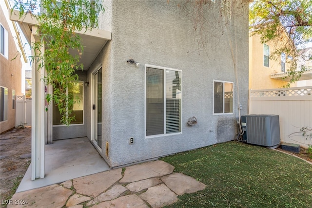 back of house with cooling unit and a patio