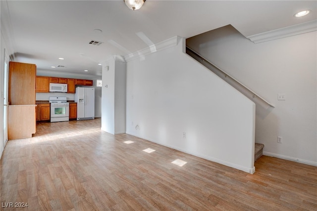 unfurnished living room featuring light wood-type flooring and crown molding