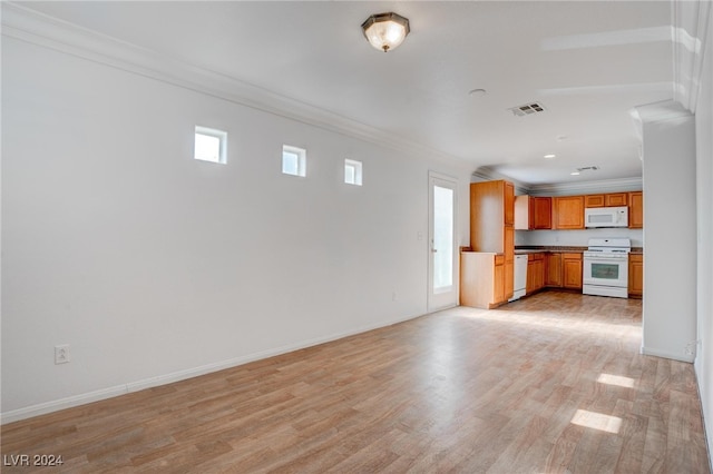 unfurnished living room featuring ornamental molding and light hardwood / wood-style flooring