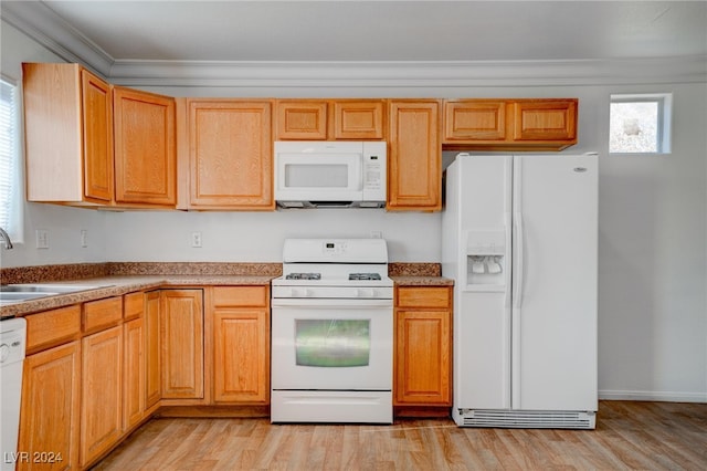 kitchen with light wood-type flooring, crown molding, sink, and white appliances