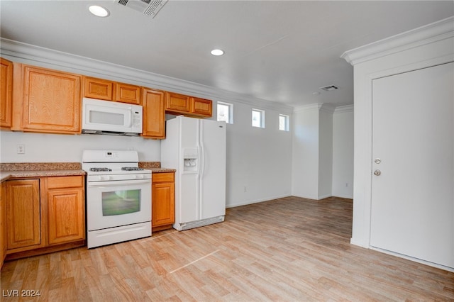 kitchen featuring light wood-type flooring, ornamental molding, and white appliances