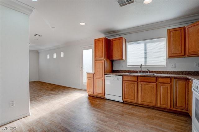 kitchen with crown molding, white appliances, sink, and light hardwood / wood-style floors