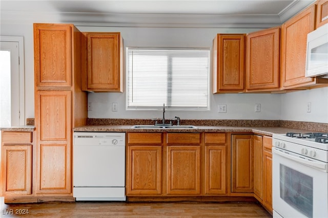 kitchen with light hardwood / wood-style flooring, white appliances, crown molding, and sink