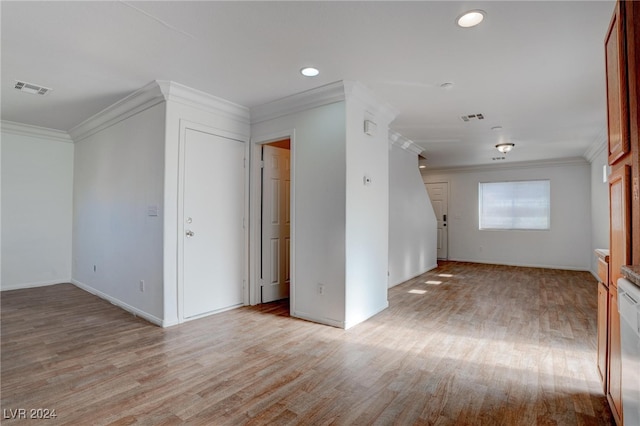 empty room with ornamental molding and light hardwood / wood-style flooring