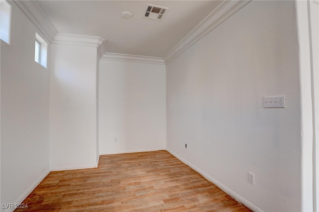 empty room featuring ornamental molding and light hardwood / wood-style floors