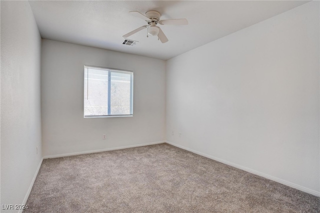 spare room featuring ceiling fan and light carpet