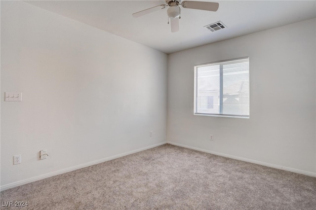 empty room featuring light carpet and ceiling fan