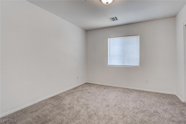 spare room featuring light colored carpet