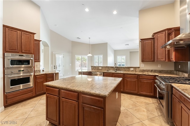 kitchen with light tile patterned floors, sink, high vaulted ceiling, appliances with stainless steel finishes, and a center island