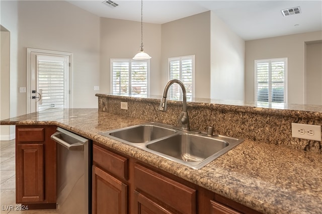 kitchen featuring pendant lighting, light tile patterned flooring, sink, and stainless steel dishwasher