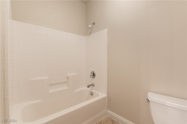 bathroom with tub / shower combination, toilet, and tile patterned floors