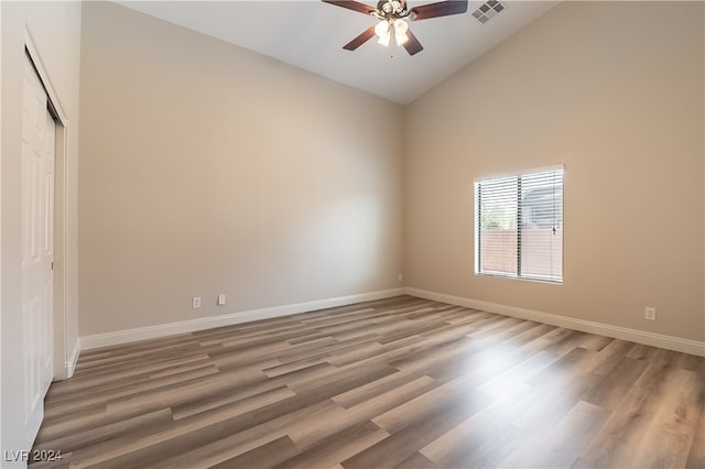 unfurnished room featuring high vaulted ceiling, hardwood / wood-style floors, and ceiling fan