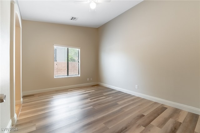 empty room featuring ceiling fan and light hardwood / wood-style flooring