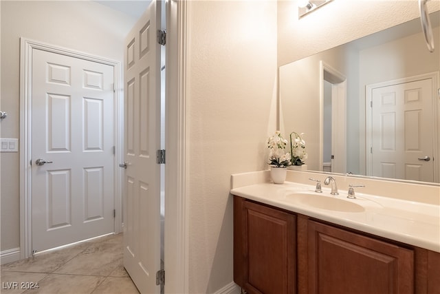 bathroom featuring tile patterned flooring and vanity