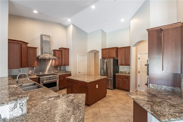 kitchen with wall chimney exhaust hood, sink, stainless steel appliances, high vaulted ceiling, and a center island