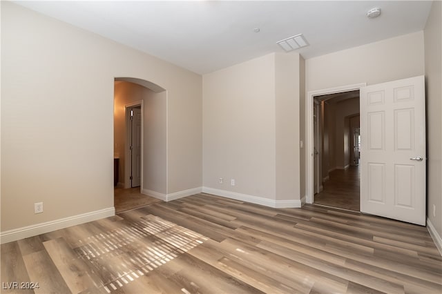 spare room with wood-type flooring