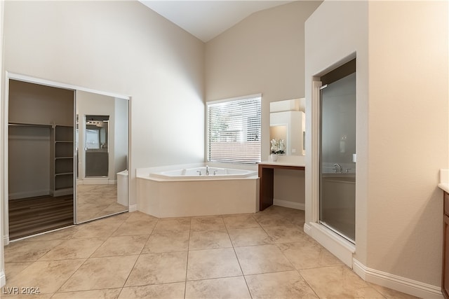 bathroom featuring tile patterned flooring, high vaulted ceiling, vanity, and independent shower and bath